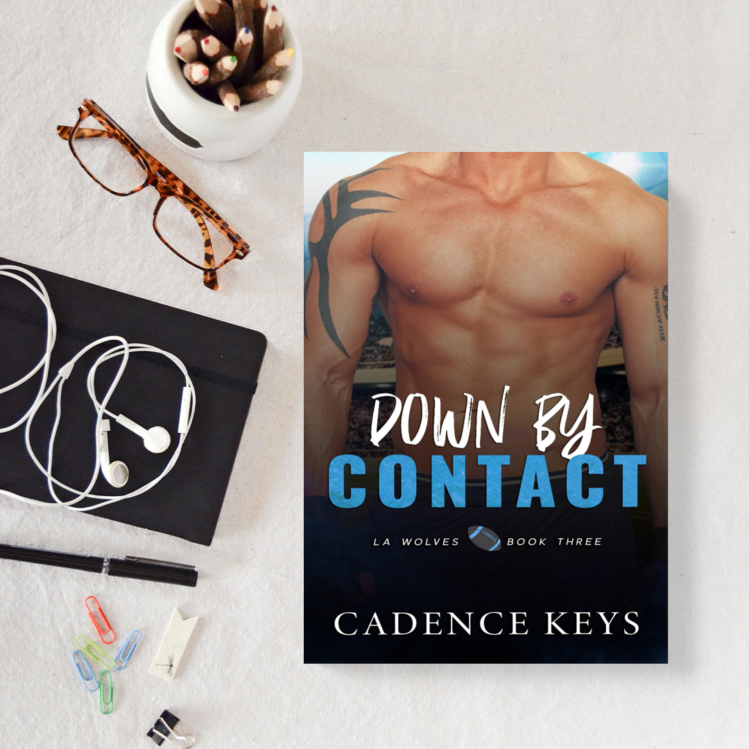 cover of down by contact by cadence keys next to some office supplies including pencils in a jar, a pair of glasses, a notebook with white headphones on top, a pen, and some paperclips